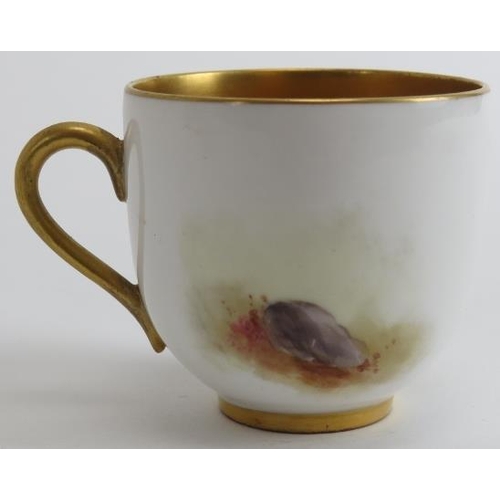 82 - A Royal Worcester gilt polychrome painted porcelain coffee cup and saucer, circa 1914. With a gilt i... 