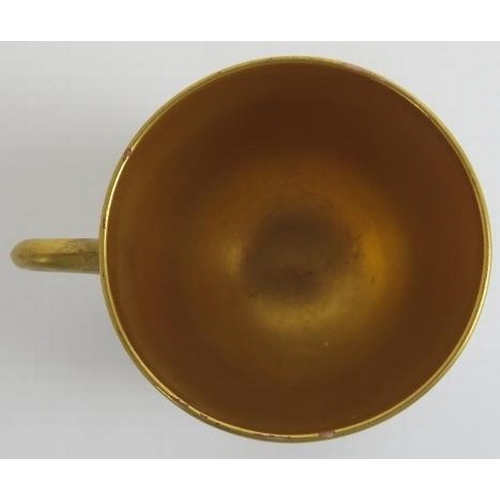 82 - A Royal Worcester gilt polychrome painted porcelain coffee cup and saucer, circa 1914. With a gilt i... 