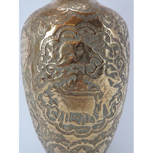 97 - A North Indian Mughal embossed brass vase, 19th century. Of ovoid form, decorated with a variety of ... 