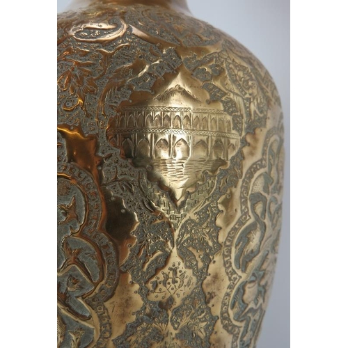 97 - A North Indian Mughal embossed brass vase, 19th century. Of ovoid form, decorated with a variety of ... 