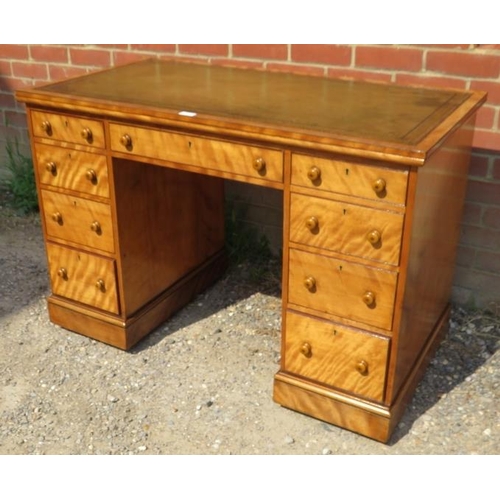 704 - A Victorian birch kneehole desk, the top with inset tooled green leather writing surface, above a co... 