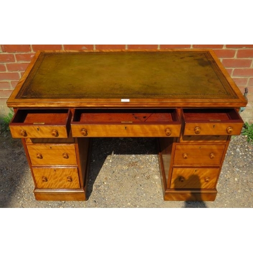 704 - A Victorian birch kneehole desk, the top with inset tooled green leather writing surface, above a co... 