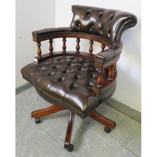 705 - An antique style mahogany captain’s height adjustable swivel desk chair, upholstered in buttoned gre... 