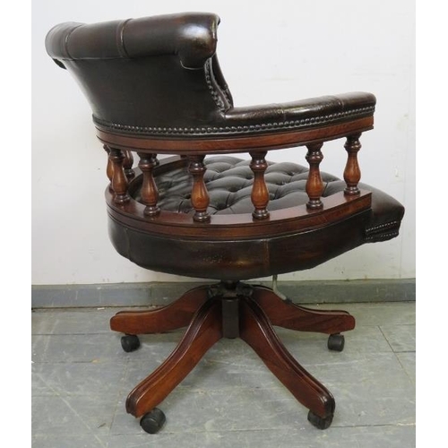 705 - An antique style mahogany captain’s height adjustable swivel desk chair, upholstered in buttoned gre... 