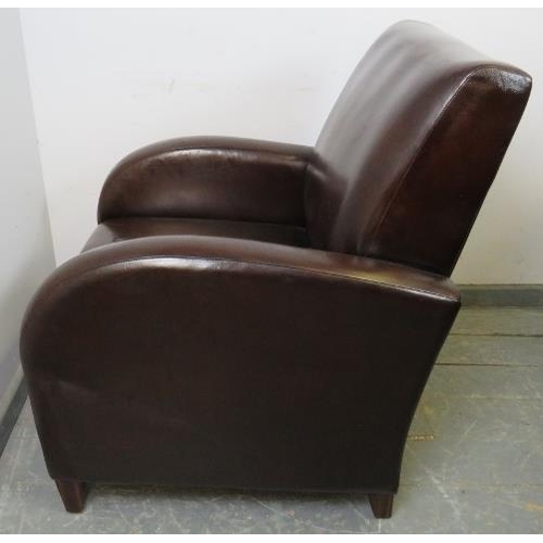 709 - An Art Deco style club armchair, upholstered in brown leather, on tapering square coromandel support... 