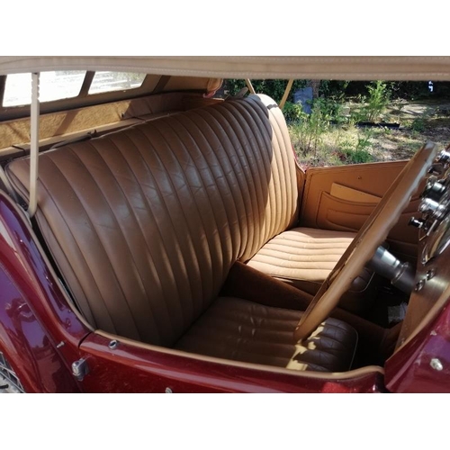 710 - A 1948 MG TC 1250cc roadster, the cranberry red coachwork complimented by a contrasting oatmeal hide... 