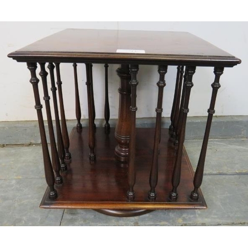 714 - An Edwardian mahogany revolving tabletop bookcase of small proportions, featuring turned side spindl... 