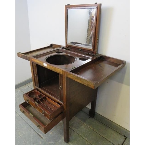 719 - A George III mahogany gentleman’s vanity unit, the doors opening onto a fitted interior with rising ... 