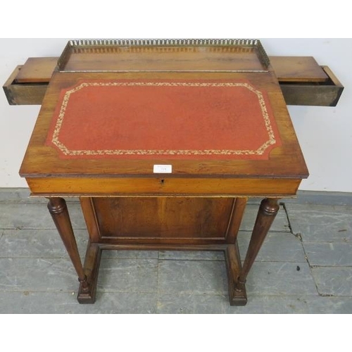 724 - A reproduction Yew wood Davenport, with brass ¾ gallery and inset red leather writing surface, housi... 