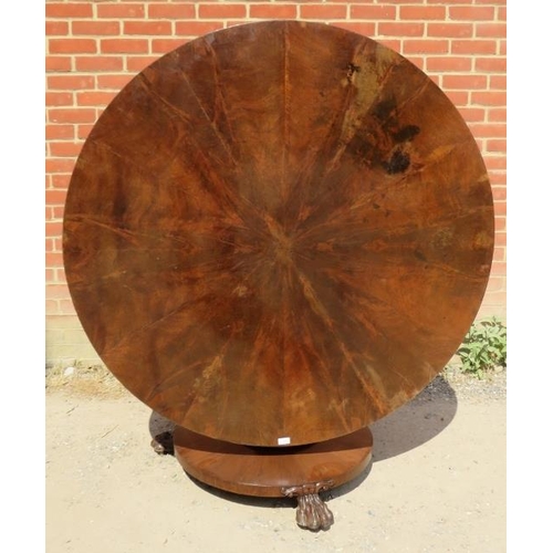 725 - An early Victorian mahogany circular tilt-top dining table, the top with sectioned veneer, on a bulb... 