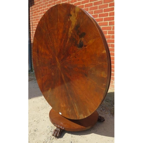 725 - An early Victorian mahogany circular tilt-top dining table, the top with sectioned veneer, on a bulb... 