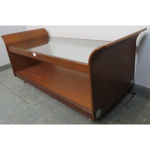 727 - A mid-century teak ‘Tulip’ coffee table by G Plan, the glass top above an undertier shelf, on castor... 