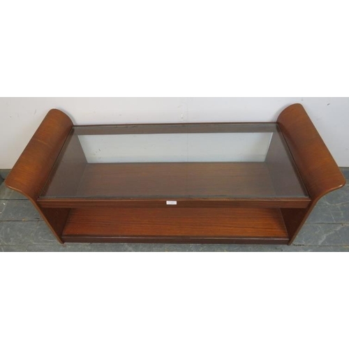 727 - A mid-century teak ‘Tulip’ coffee table by G Plan, the glass top above an undertier shelf, on castor... 