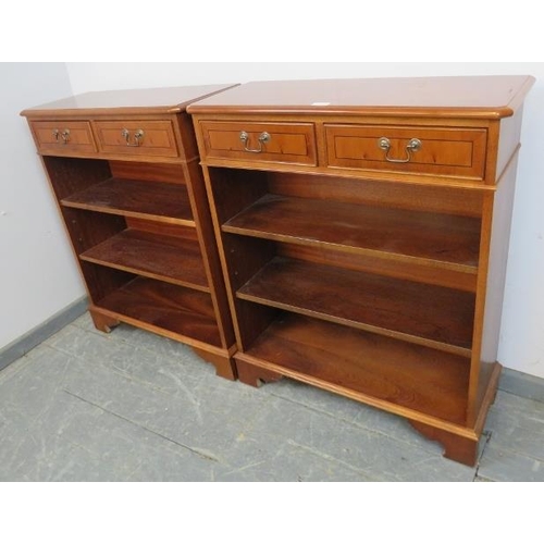 731 - A pair of reproduction Yew wood open bookcases, crossbanded and strung with ebony, each housing two ... 