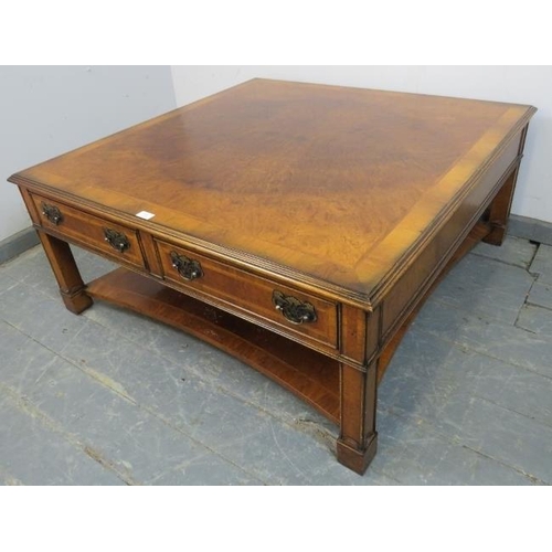 733 - A large square burr walnut two-tier coffee table, crossbanded and quarter veneered, housing two shor... 