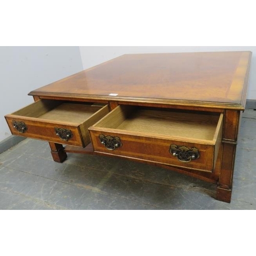 733 - A large square burr walnut two-tier coffee table, crossbanded and quarter veneered, housing two shor... 