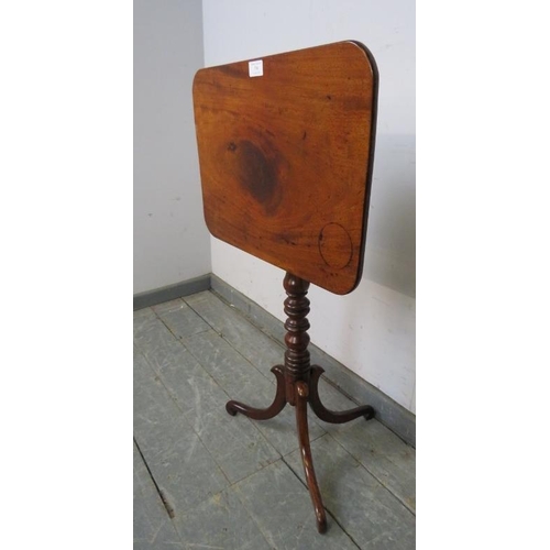 736 - A late Georgian mahogany rectangular tilt-top wine table, on a turned column with splayed tripod sup... 