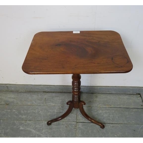 736 - A late Georgian mahogany rectangular tilt-top wine table, on a turned column with splayed tripod sup... 