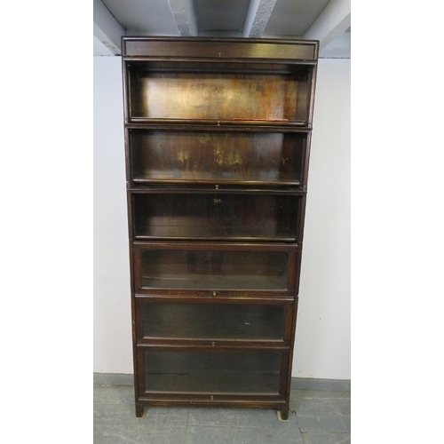 738 - A vintage oak six section Globe-Wernicke style stacking bookcase, with glazed rising doors, on squar... 