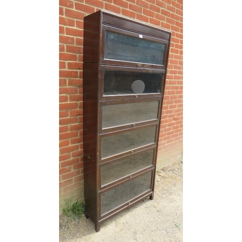 739 - A vintage oak six section Globe-Wernicke style stacking bookcase, with glazed rising doors, on squar... 