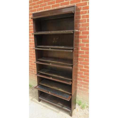 739 - A vintage oak six section Globe-Wernicke style stacking bookcase, with glazed rising doors, on squar... 