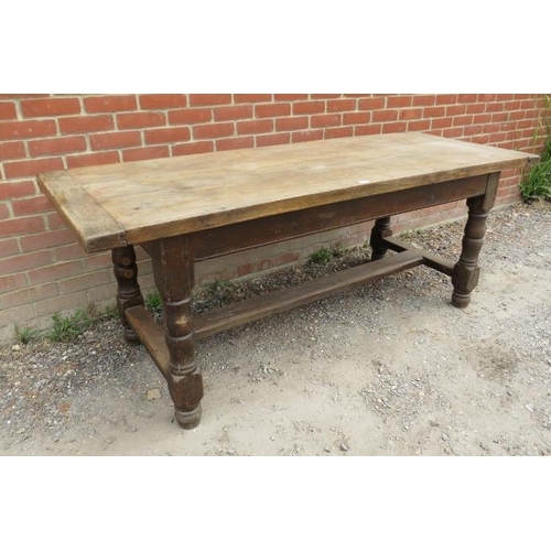 741 - A 19th century elm refectory table, on baluster turned and block supports united by an ‘H’ stretcher... 