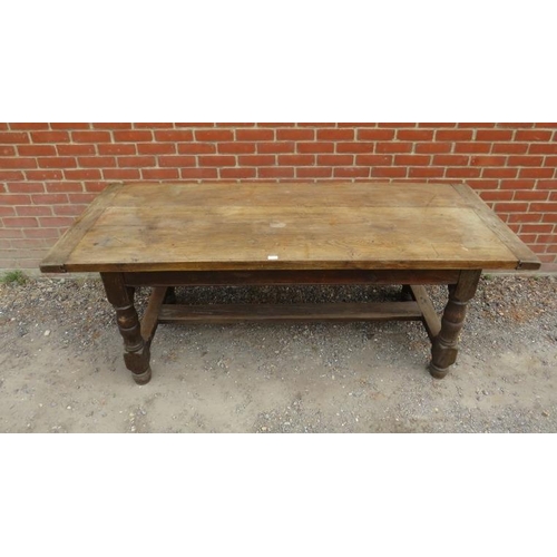 741 - A 19th century elm refectory table, on baluster turned and block supports united by an ‘H’ stretcher... 