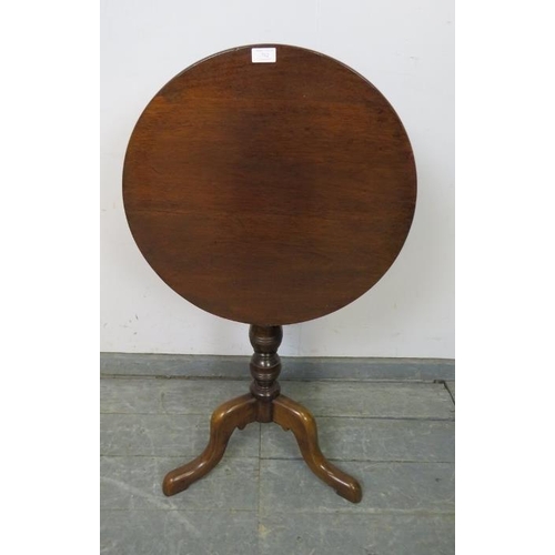 742 - A 19th century mahogany circular tilt-top wine table, on a turned column with splayed tripod support... 