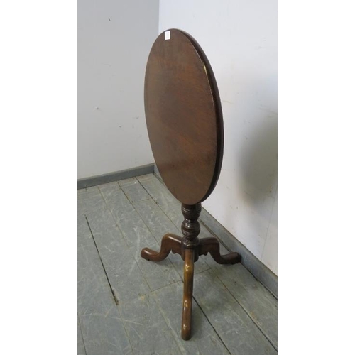 742 - A 19th century mahogany circular tilt-top wine table, on a turned column with splayed tripod support... 