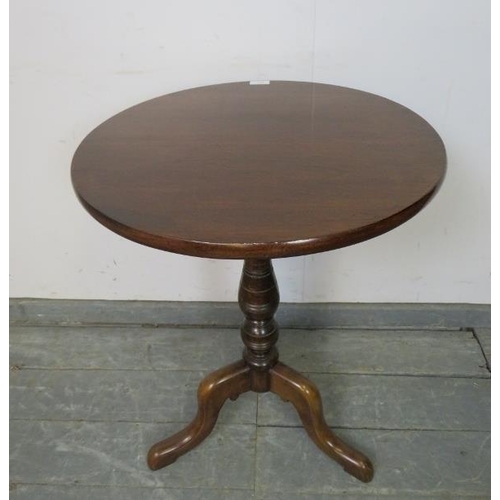 742 - A 19th century mahogany circular tilt-top wine table, on a turned column with splayed tripod support... 