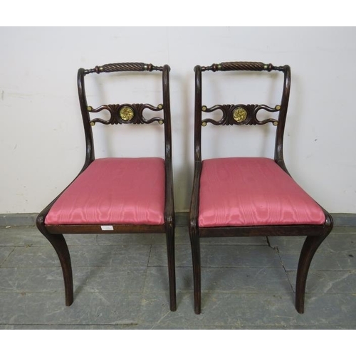 745 - A pair of Regency Period mahogany rope back side chairs, the carved backrests with gilt brass rounde... 