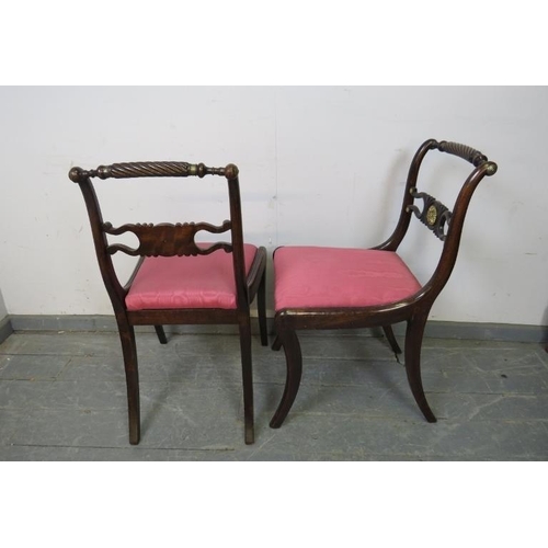 745 - A pair of Regency Period mahogany rope back side chairs, the carved backrests with gilt brass rounde... 