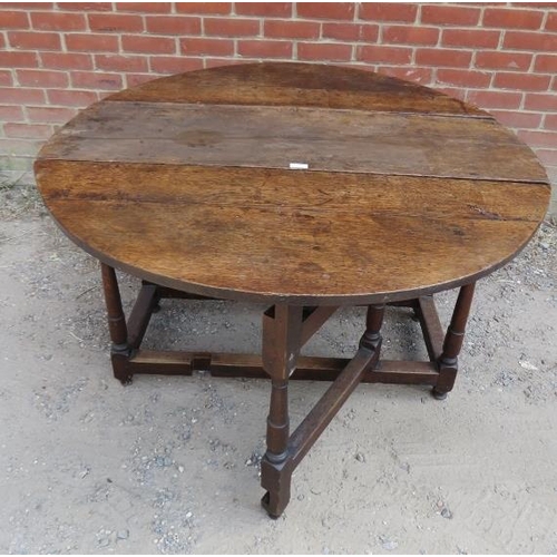 749 - An 18th century oak oval gate-leg table, with single drawer, on tapering supports with stretchers. 
... 