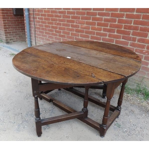 749 - An 18th century oak oval gate-leg table, with single drawer, on tapering supports with stretchers. 
... 