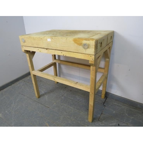 750 - A vintage elm butcher’s block of great character, on an associated pine stand. 
H92cm W92cm D62cm (a... 