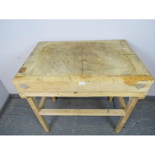 750 - A vintage elm butcher’s block of great character, on an associated pine stand. 
H92cm W92cm D62cm (a... 