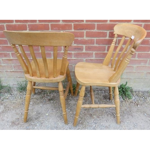 754 - A set of four beech slat-back farmhouse kitchen chairs, on turned canted supports with an ‘H’ stretc... 