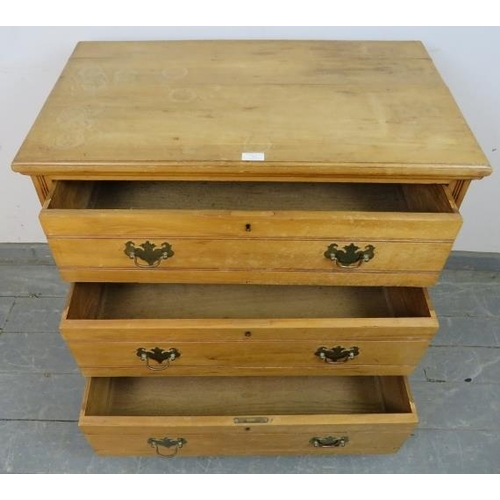 761 - An Edwardian lightwood chest of three long drawers with brass batwing handles, on reeded supports.
H... 