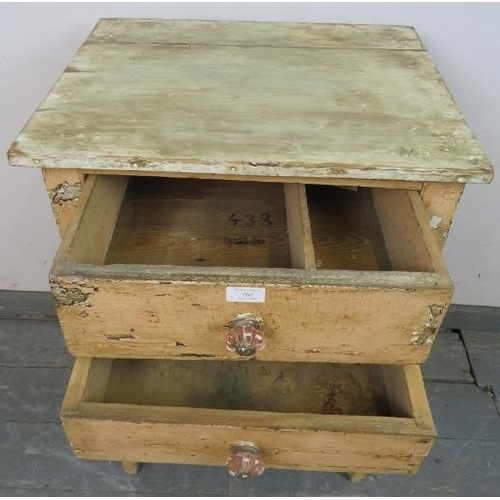 762 - An antique pine artist’s cabinet, painted in a distressed effect, housing two drawers above two open... 