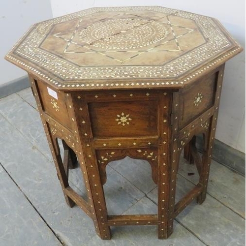 767 - An antique Indian hardwood octagonal Hohshiapur occasional table, on a folding base with Moorish arc... 