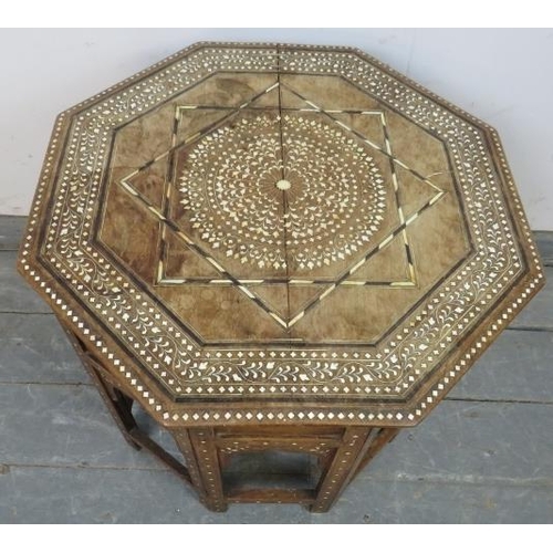 767 - An antique Indian hardwood octagonal Hohshiapur occasional table, on a folding base with Moorish arc... 