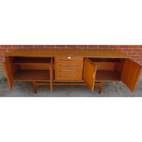 772 - A mid-century teak ‘Fresco’ sideboard by G-Plan, housing four long drawers flanked by cupboard with ... 