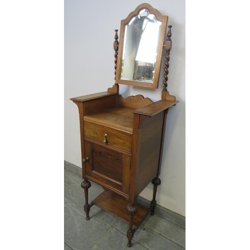 776 - An Edwardian walnut gentleman’s shaving stand, the bevelled mirror with barley twist uprights, above... 