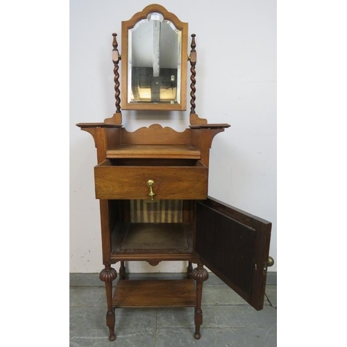 776 - An Edwardian walnut gentleman’s shaving stand, the bevelled mirror with barley twist uprights, above... 