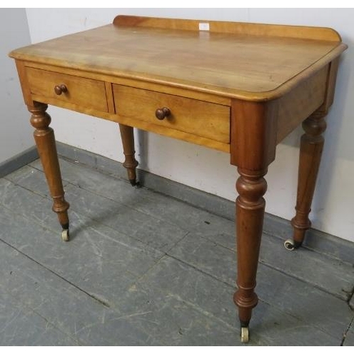 778 - A Victorian walnut writing table with rear gallery, housing two short drawers with turned wooden kno... 