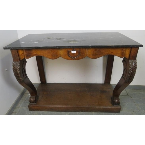 779 - A 19th century oak console table with black marble loose top, central shield decoration and curved s... 