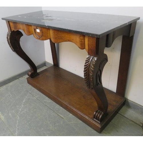 779 - A 19th century oak console table with black marble loose top, central shield decoration and curved s... 