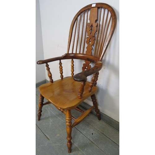 782 - A reproduction Yew wood hoop-back Windsor chair by Barry Murphy, with shaped and pierced back splat,... 