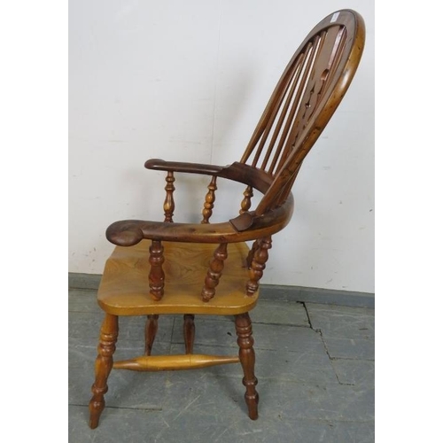 782 - A reproduction Yew wood hoop-back Windsor chair by Barry Murphy, with shaped and pierced back splat,... 