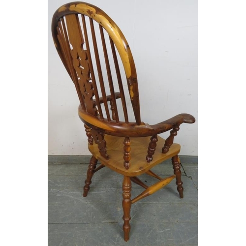 782 - A reproduction Yew wood hoop-back Windsor chair by Barry Murphy, with shaped and pierced back splat,... 